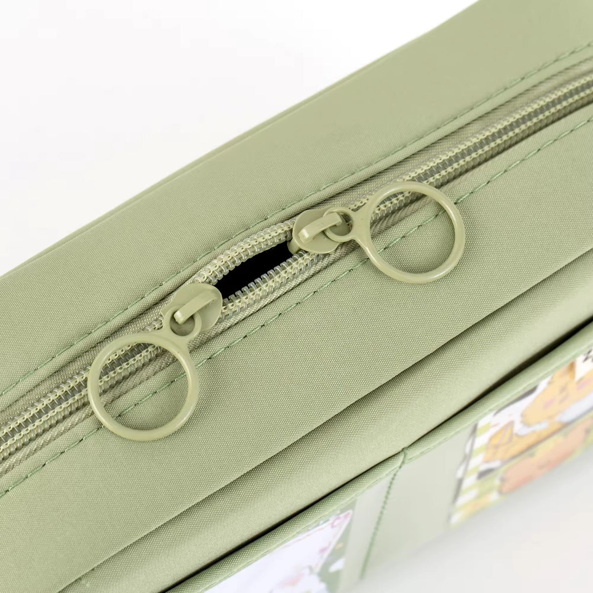Close-up of green pencil case zipper and front pocket