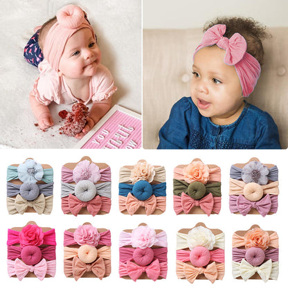 Babies wearing soft headbands above a selection of colorful headband sets