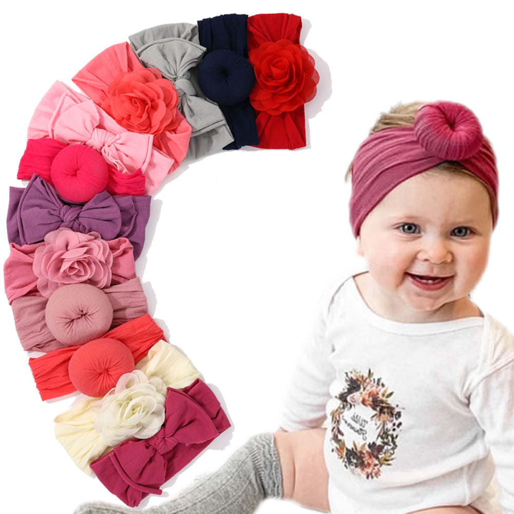 Baby wearing a burgundy headband beside assorted colorful headbands