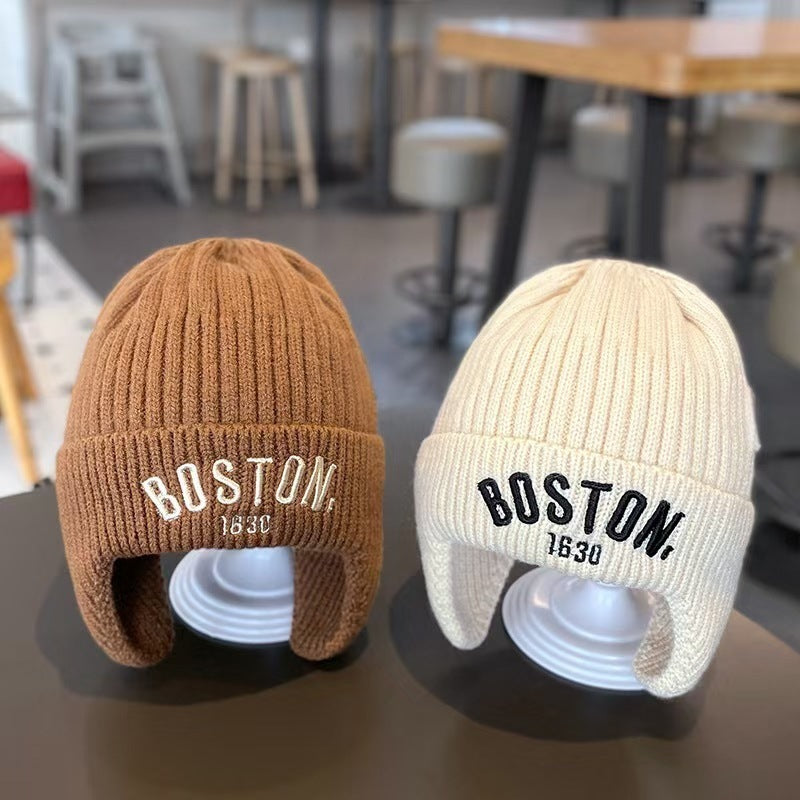 Brown and cream white ear-flap beanies displayed together