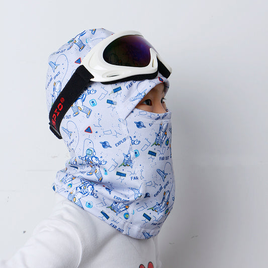 Child wearing a pale blue printed balaclava with ski goggles