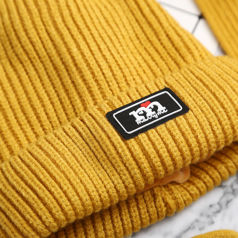 Close-up of mustard yellow knit hat ribbing and label