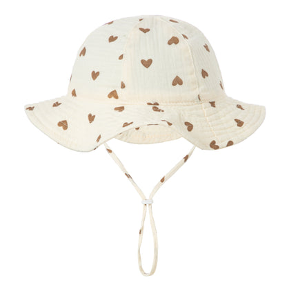 Cream baby sun hat with brown heart print and chin strap