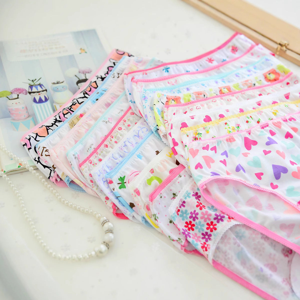 Girls underwear laid flat with pink trim and assorted prints