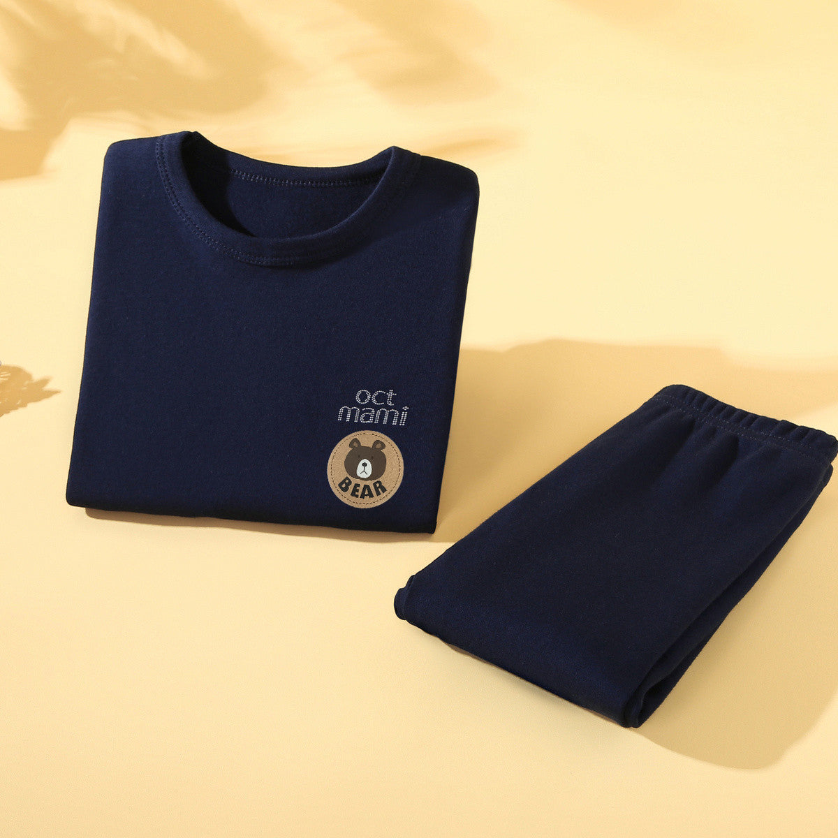 Navy blue kids long-sleeve base layer top and pants folded together