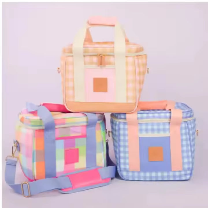 Peach, blue and pink patchwork lunch bags displayed together
