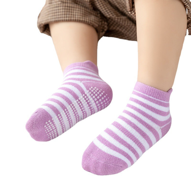 Pink and purple striped toddler socks worn on feet