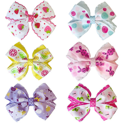 Six patterned bow hair clips arranged in three rows