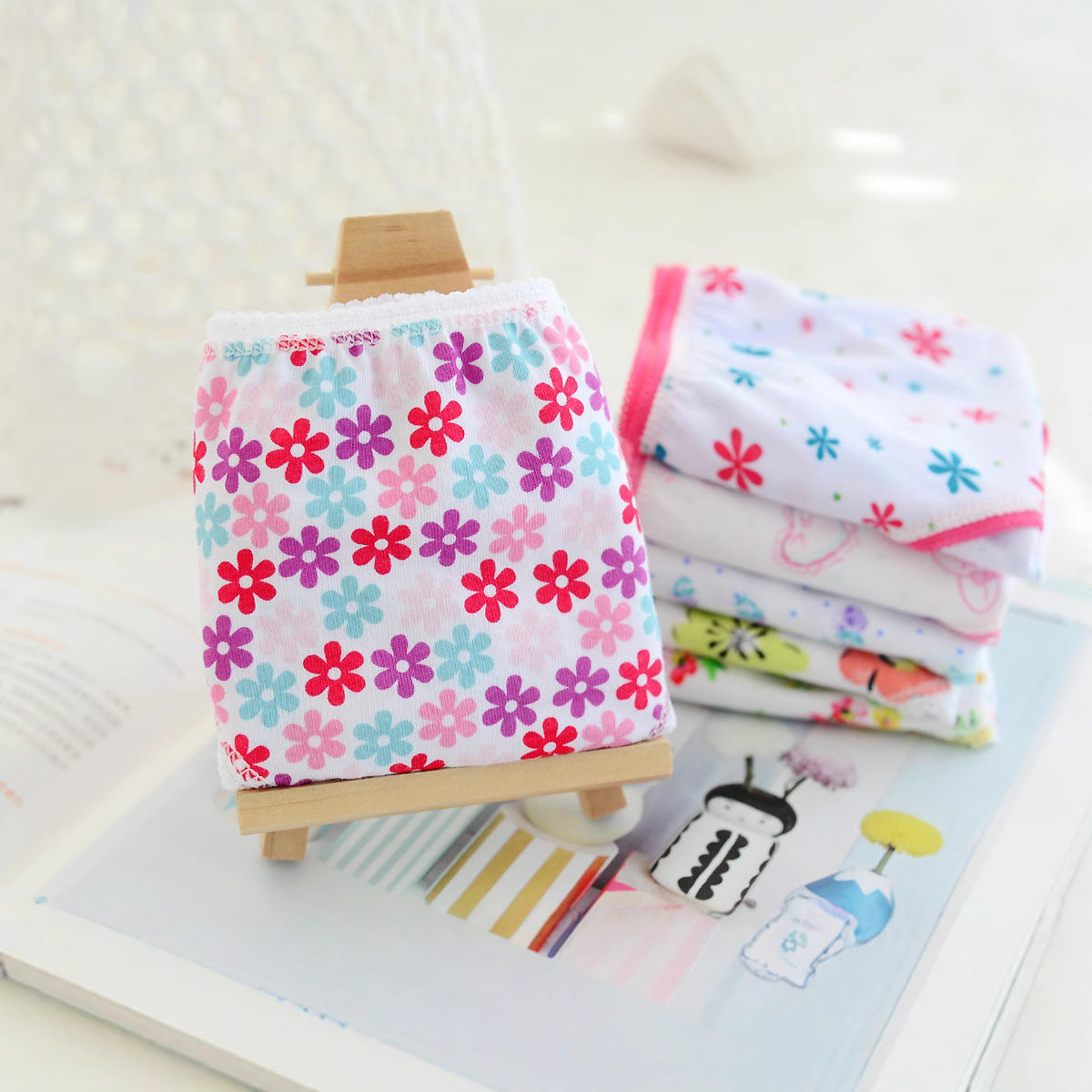 Stacks of folded floral girls underwear in pink and blue