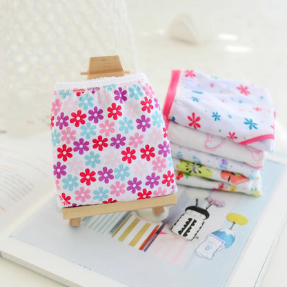 Stacks of folded floral girls underwear in pink and blue
