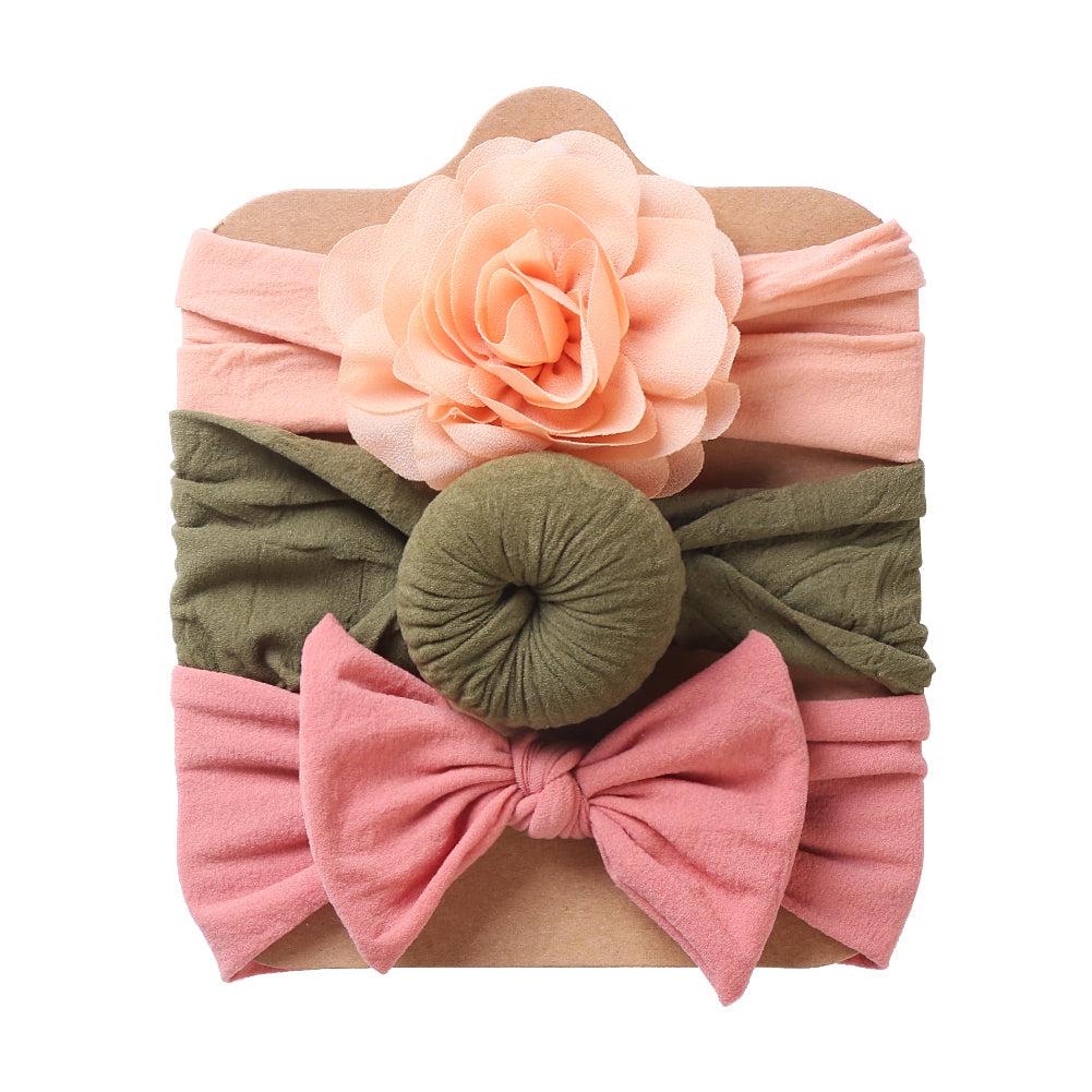 Three baby headbands with peach flower, green round knot and pink bow