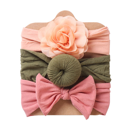 Three baby headbands with peach flower, green round knot and pink bow