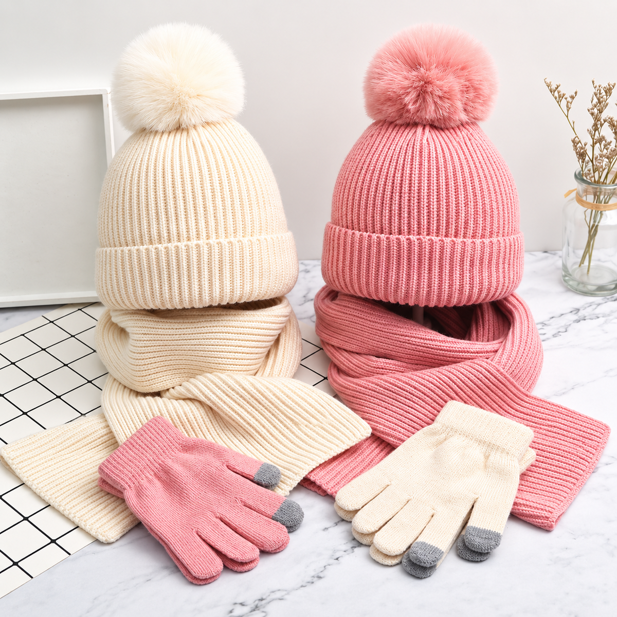 White and pink knit hat, scarf and glove sets displayed together