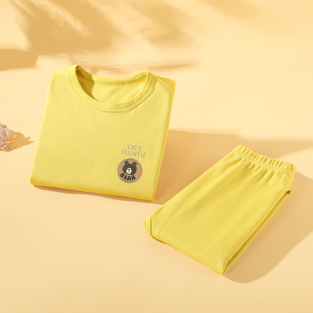Yellow kids long-sleeve base layer top and pants folded together