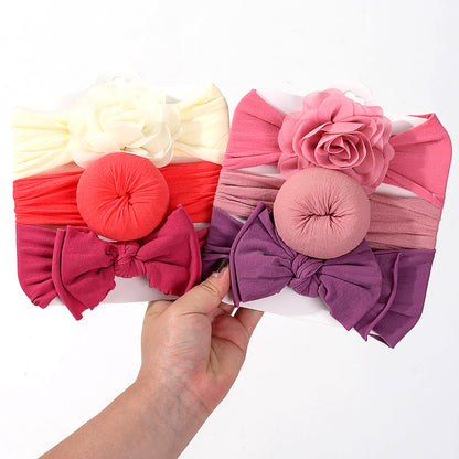 Yellow, red and purple baby headbands held together